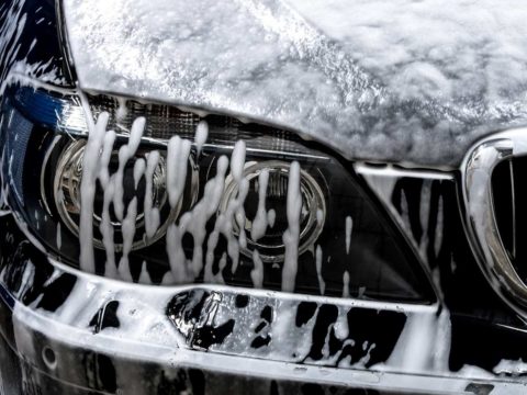 Closeup of a soapy, black sedan